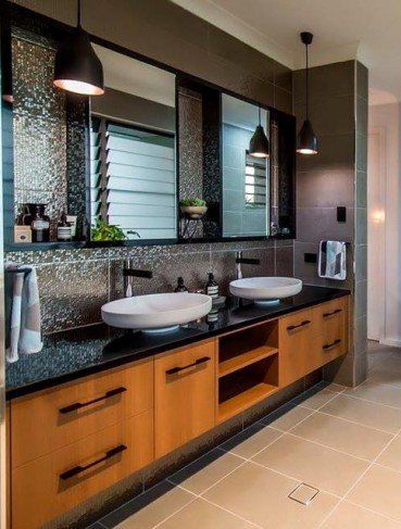 modern bathroom renovation with black marble and timber vanity in Mackay