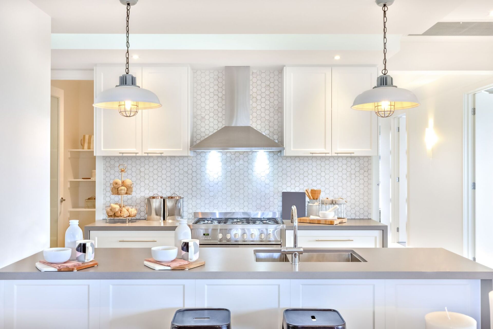 custom white kitchen designed with white honeycomb backsplash
