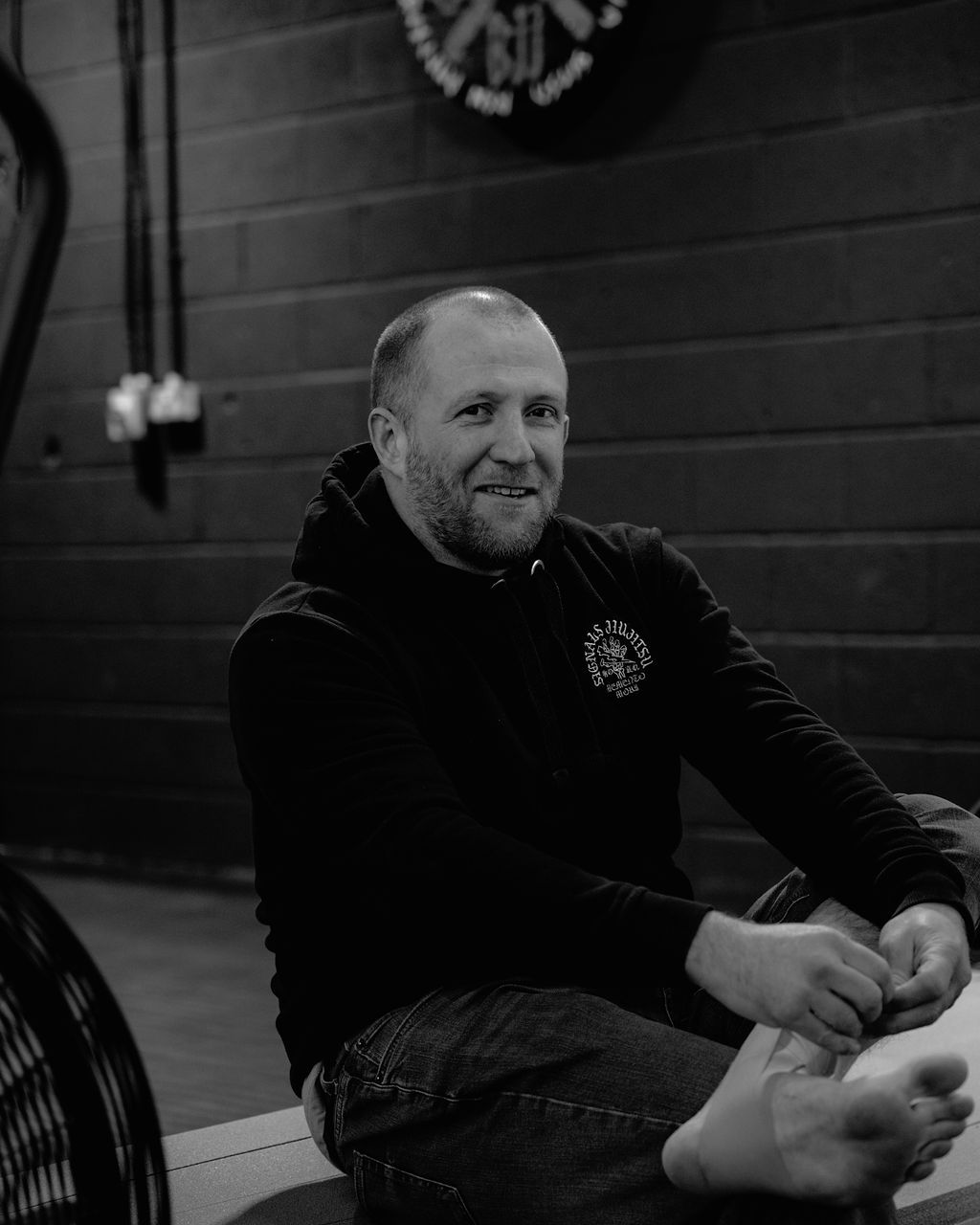a man in a suit and a t-shirt with the word break on it is standing in front of trees .