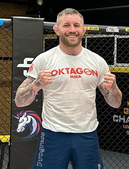 a man wearing a white shirt that says oktagon mma