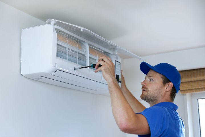 Man Fixing the Indoor Air Conditioner