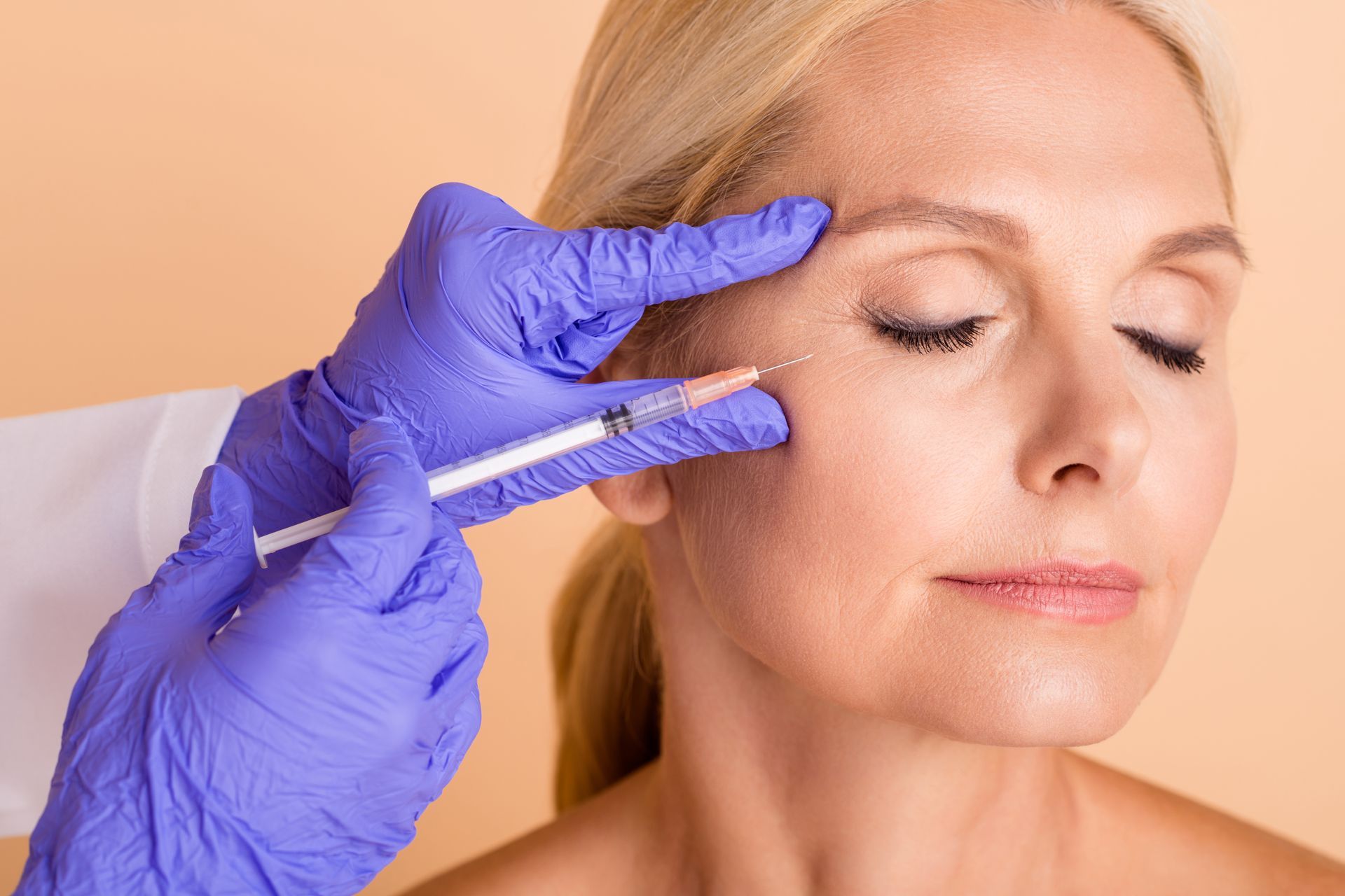 Medical professional administering a Botox injection. Medical professional administering a Botox injection.