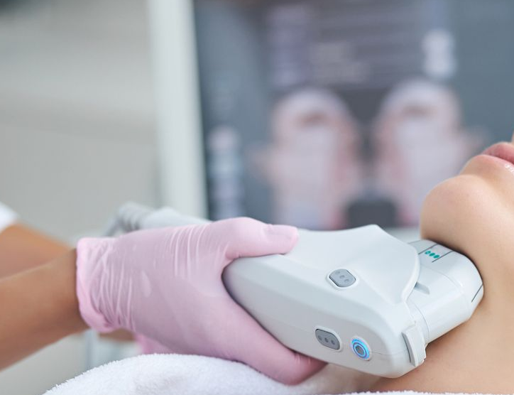 Woman receiving neck skin treatment in a clinic.