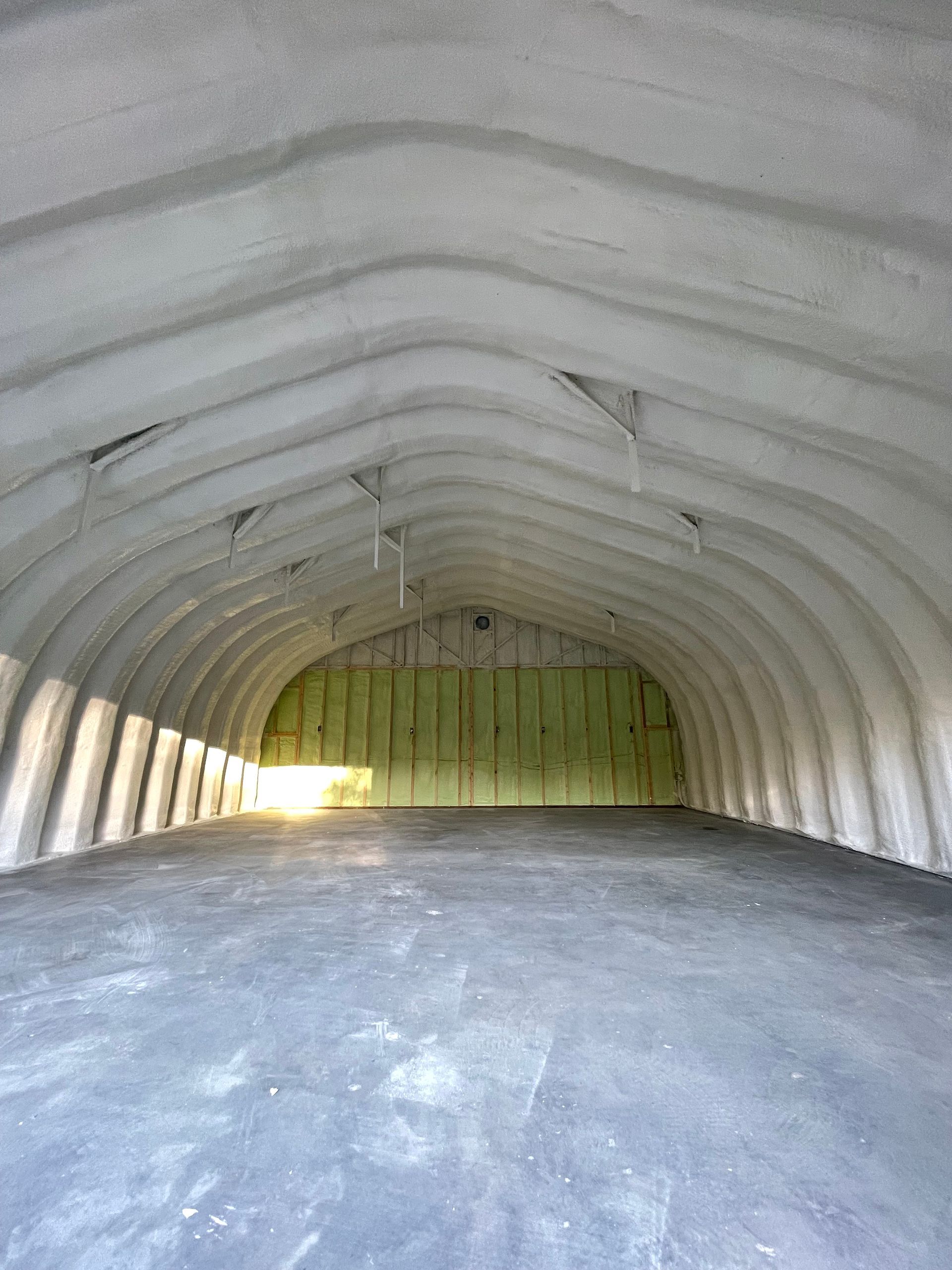 A room with wooden beams and foam insulation on the walls.
