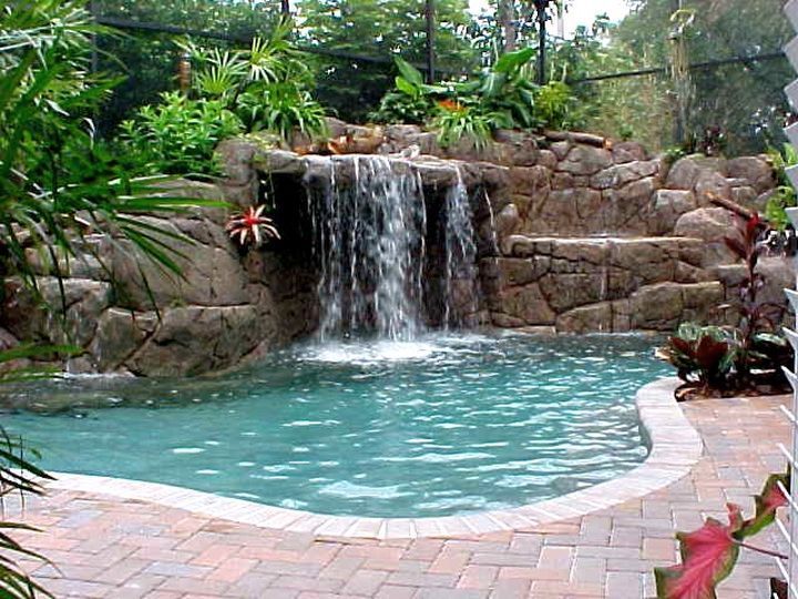 A swimming pool with a waterfall in the background