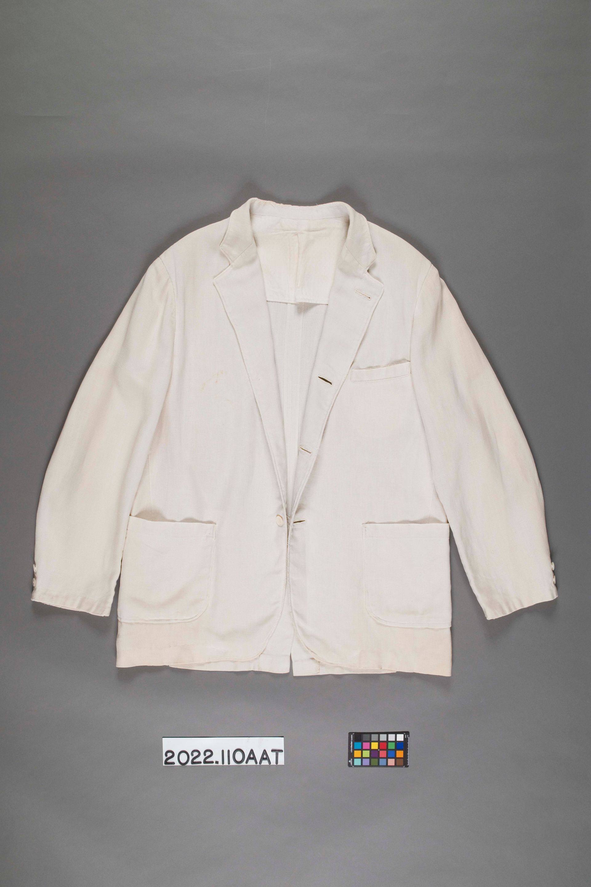A light-colored, single-breasted blazer with two patch pockets, displayed against a gray background.