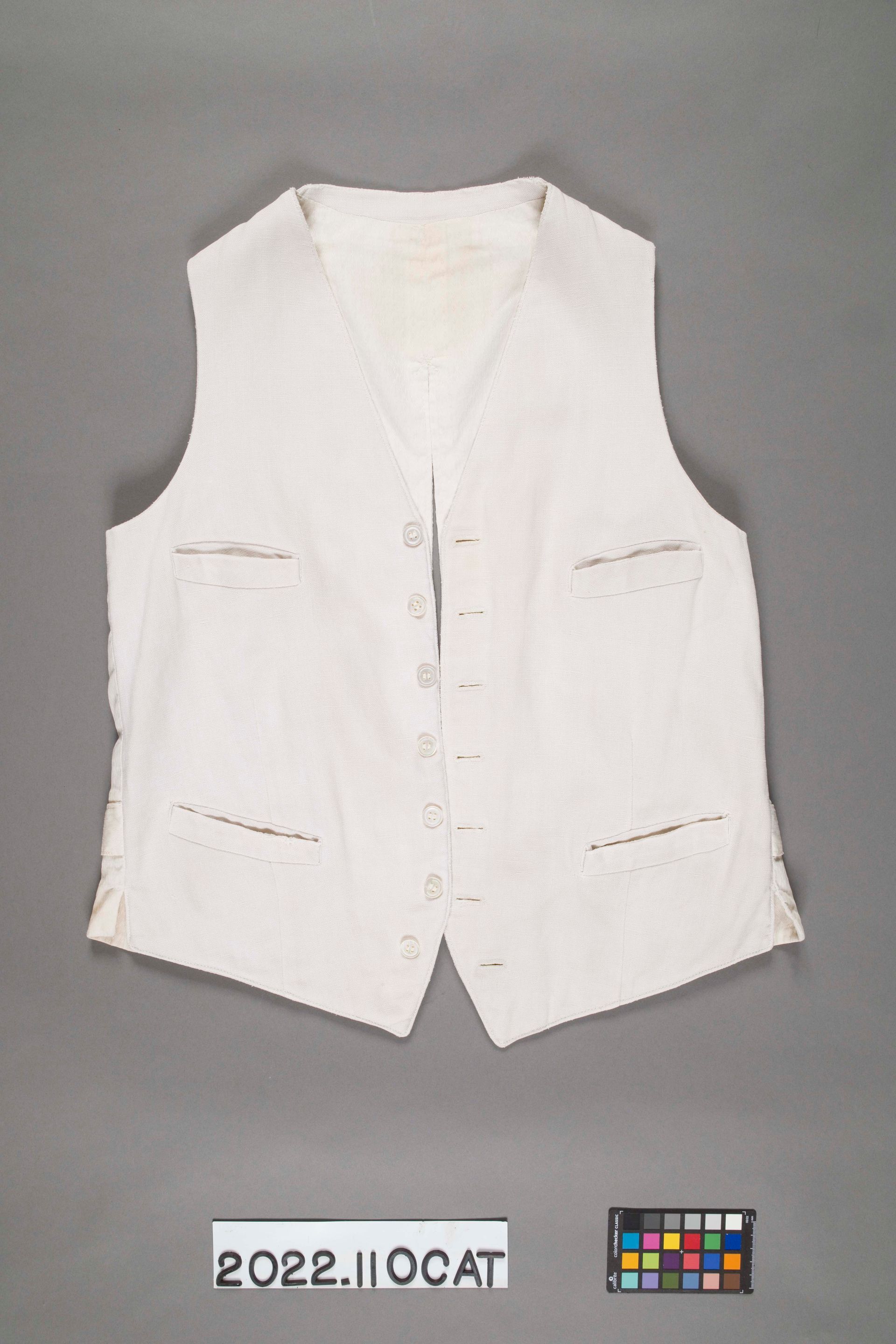 A white, sleeveless button-front vest with four small pockets against a neutral gray background.