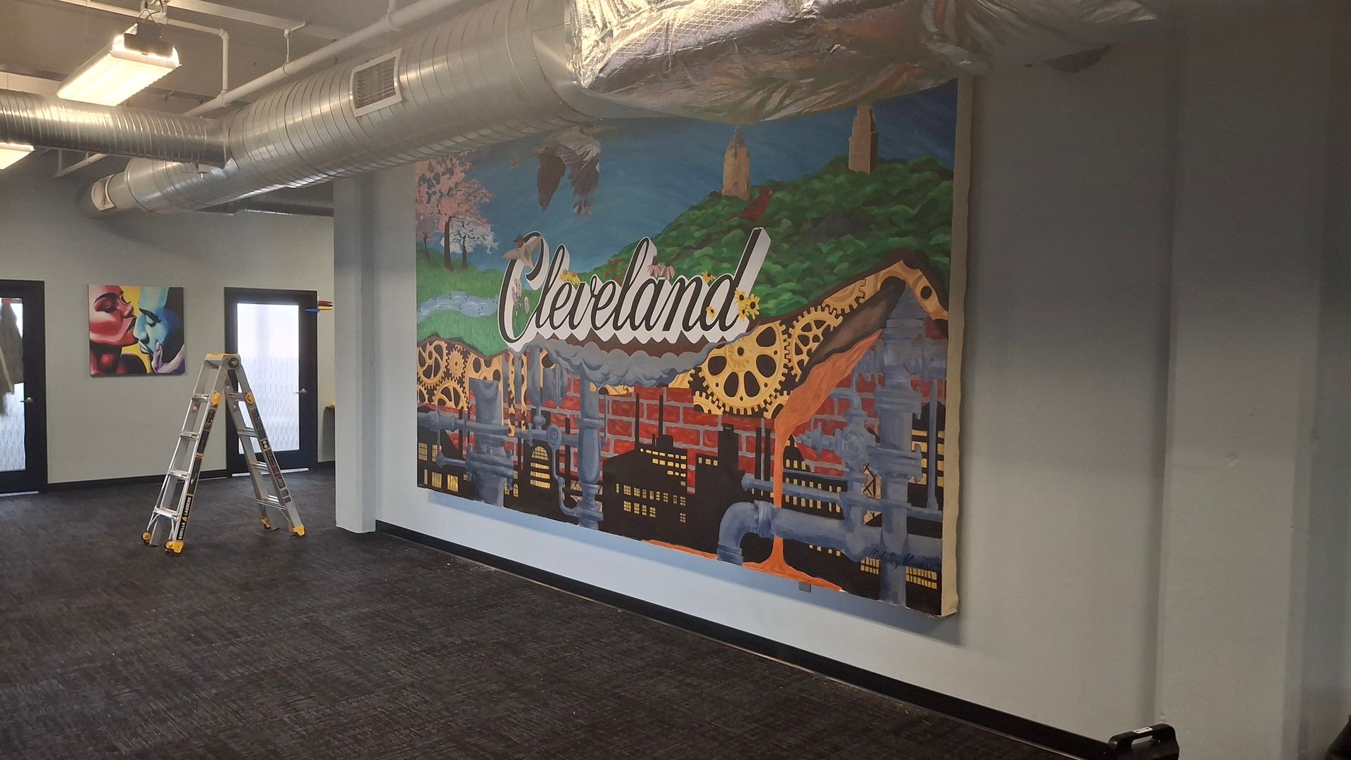 Two women are looking at a painting on the ceiling.