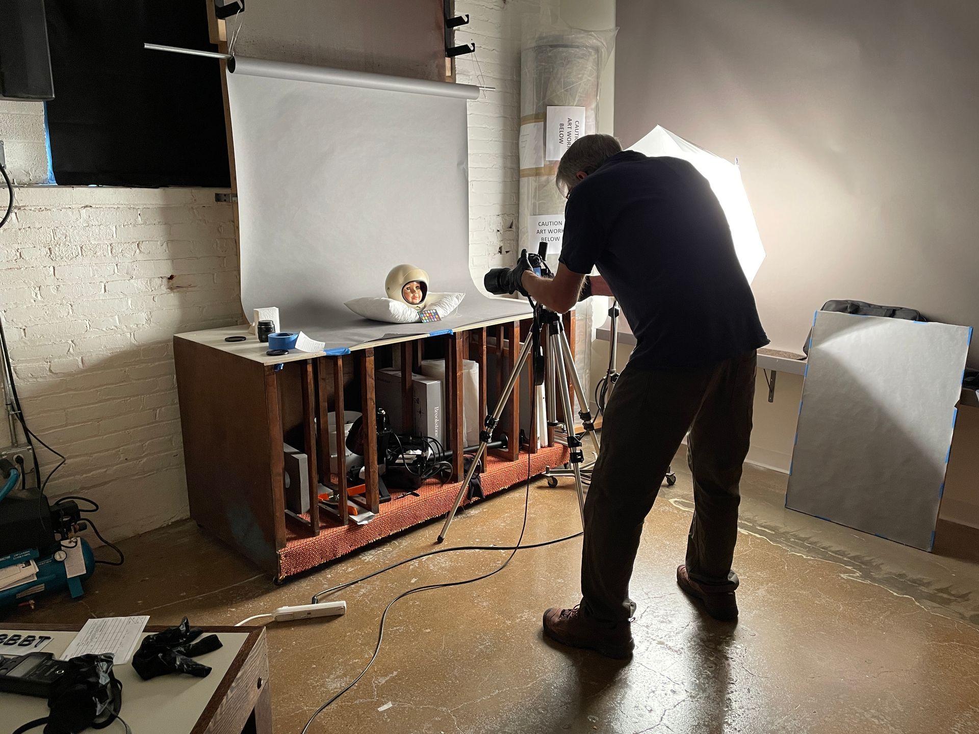 A man is taking a picture with a camera in a room.