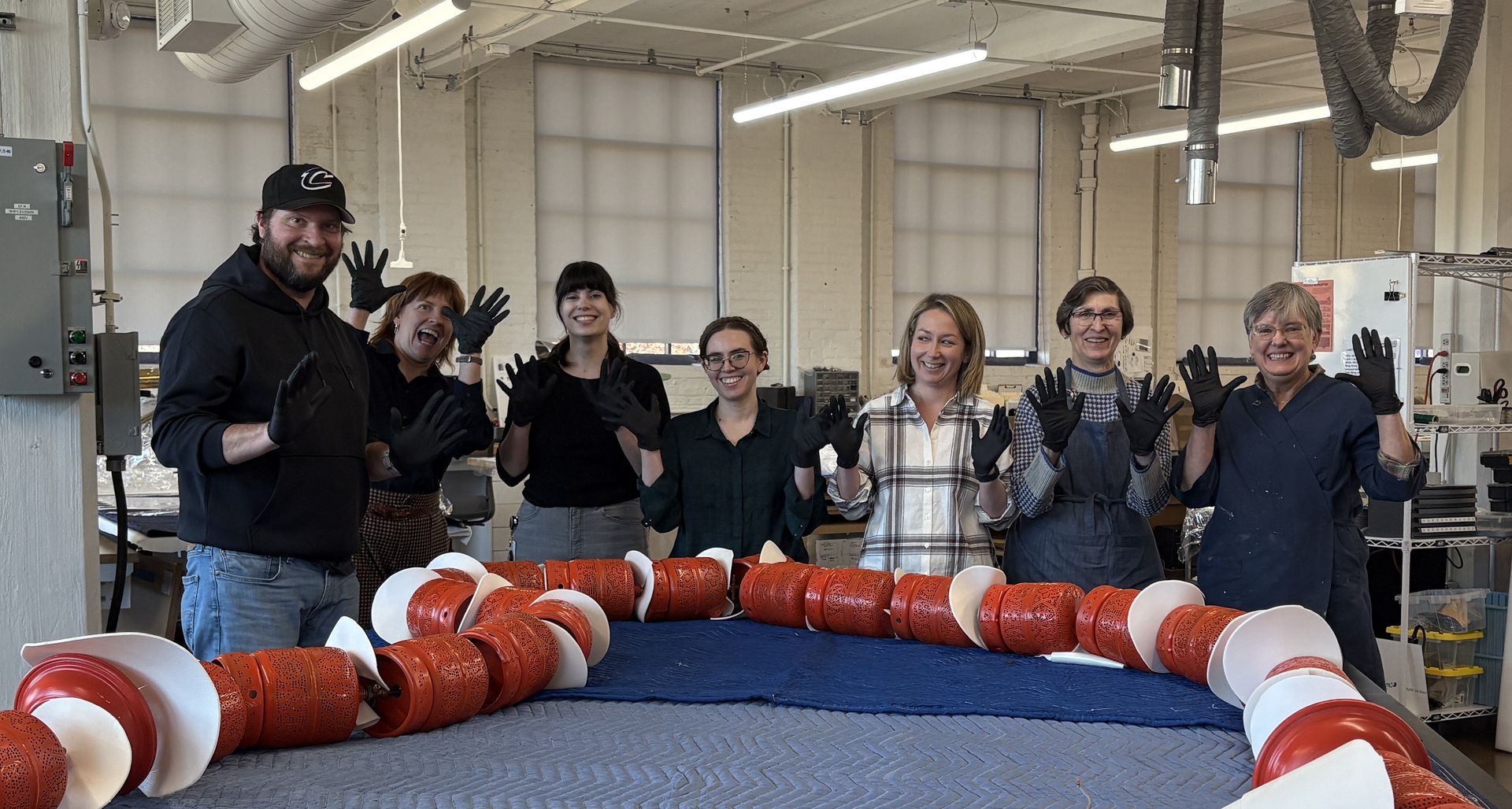 A man is working on a wooden pallet with a drill