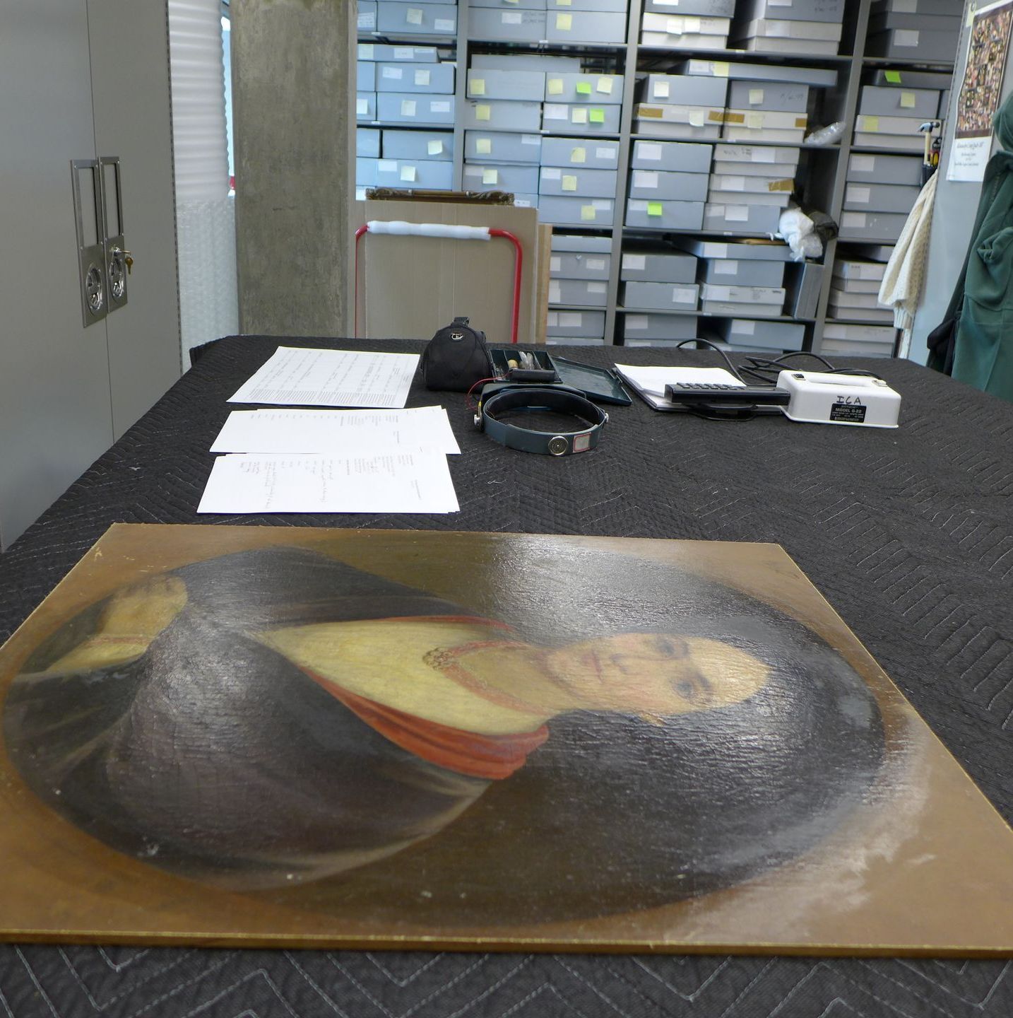 A painting of a woman laying on a table