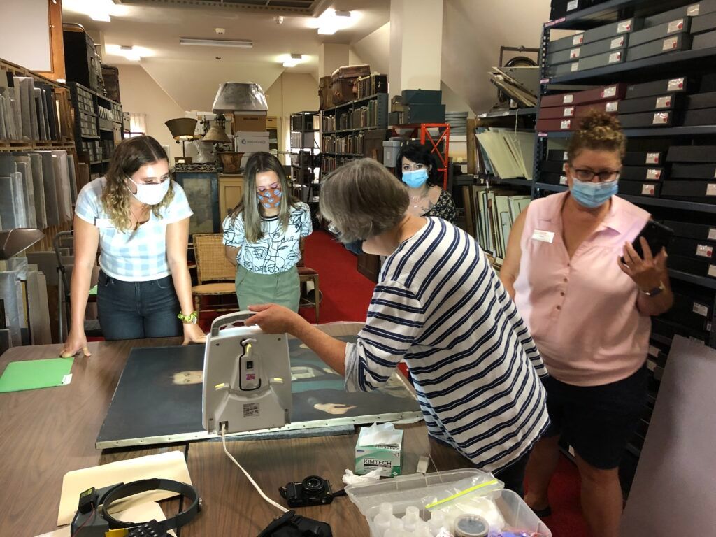 A woman is working on a sculpture in a room.