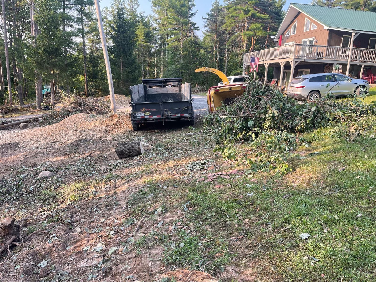 A truck is parked on the side of the road in front of a house.