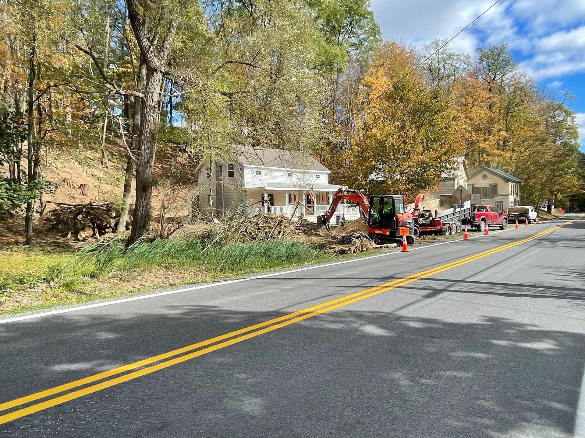 A house is being demolished on the side of the road.