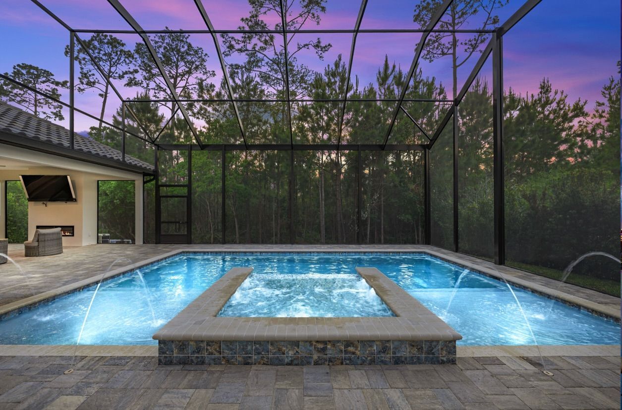 A large swimming pool with a hot tub in the middle of it