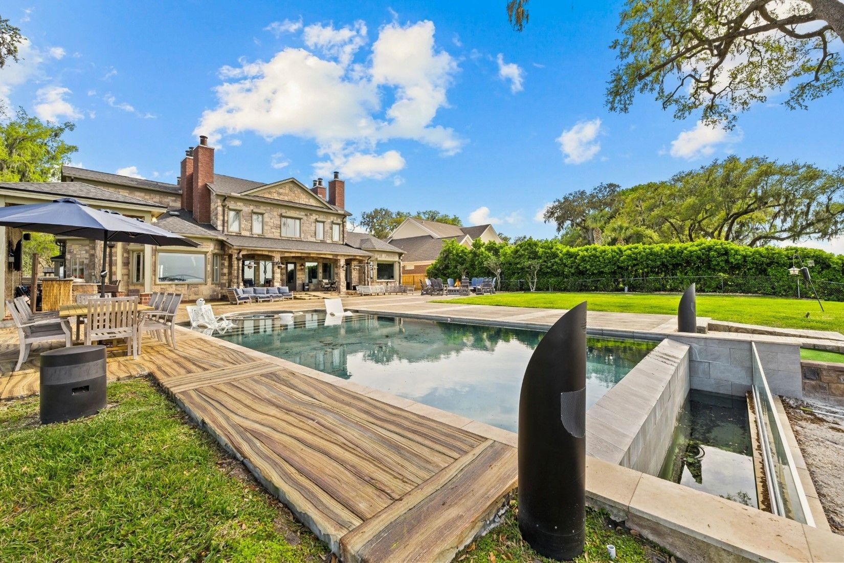 A large house with a large swimming pool in the backyard.