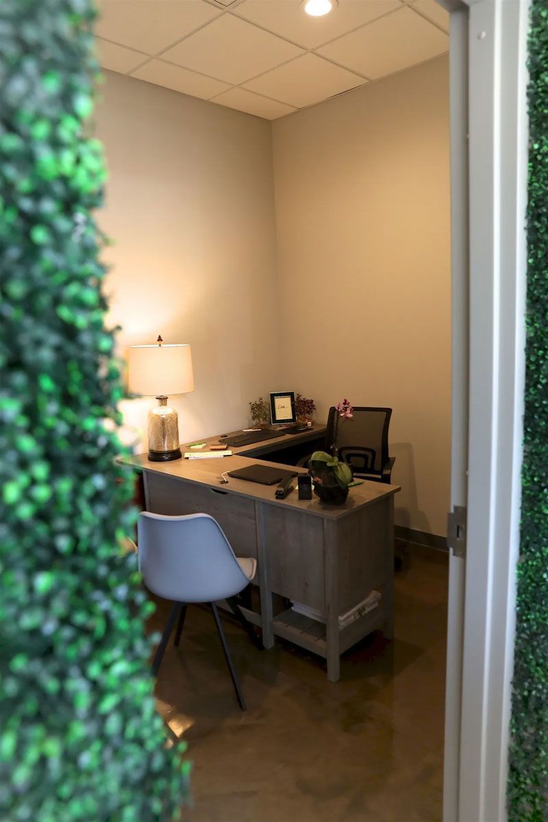 A small office with a desk , chair and computer.