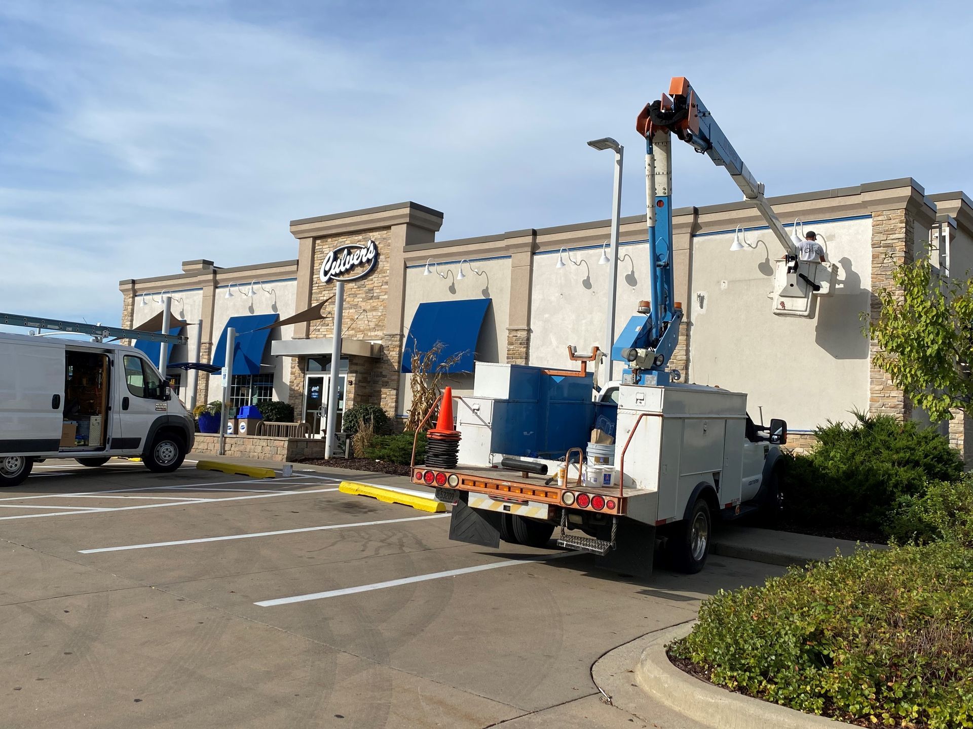 A utility truck is parked in front of a building.