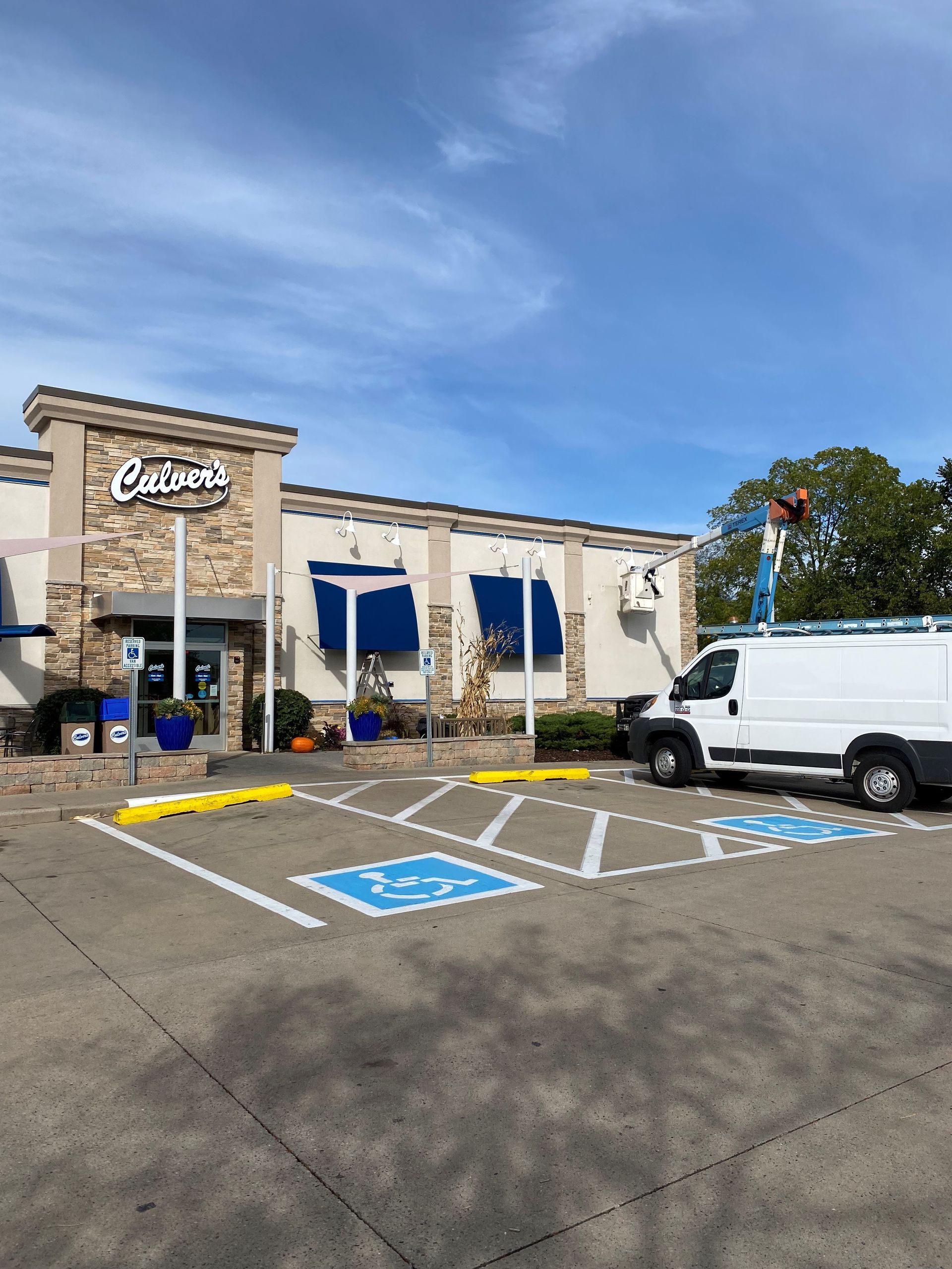 A white van is parked in front of a building