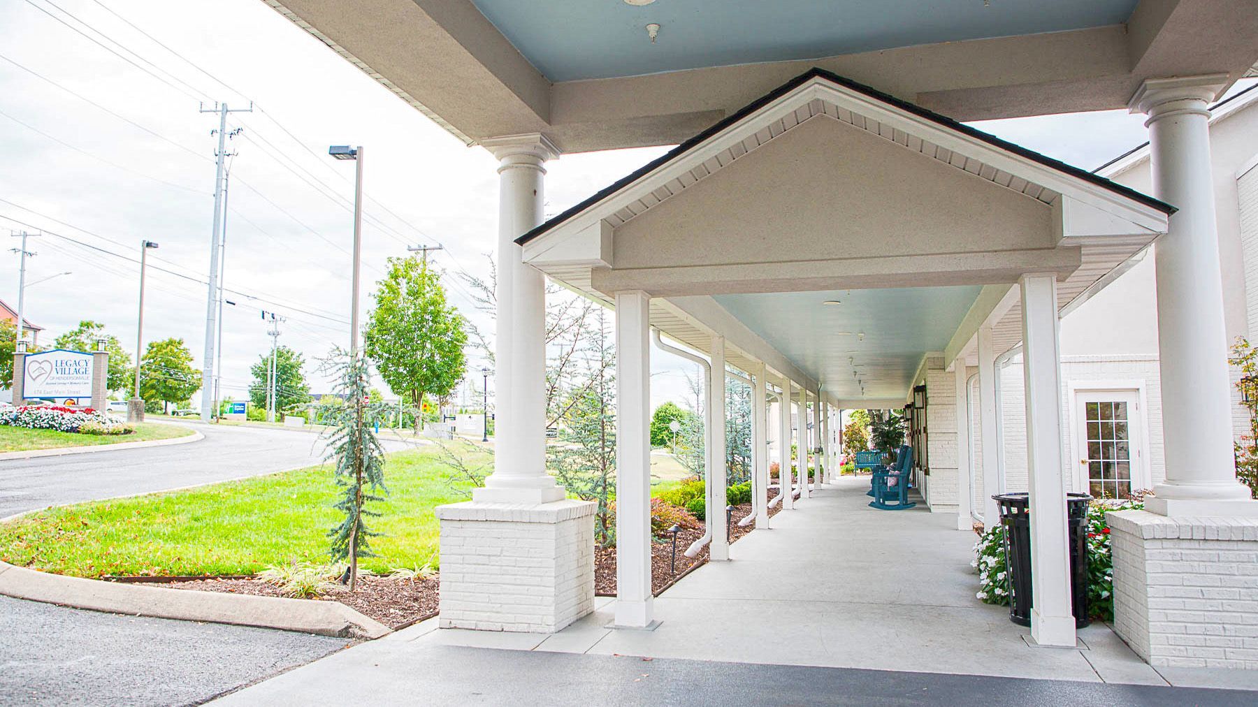A long walkway leading to a hotel with a canopy over it.