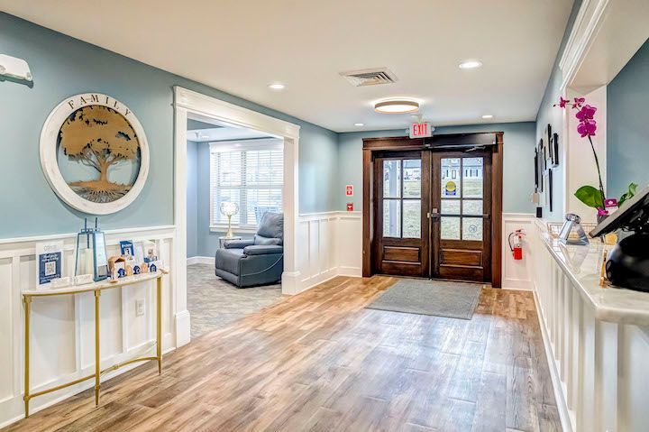 A hallway in a nursing home with a table and chairs.