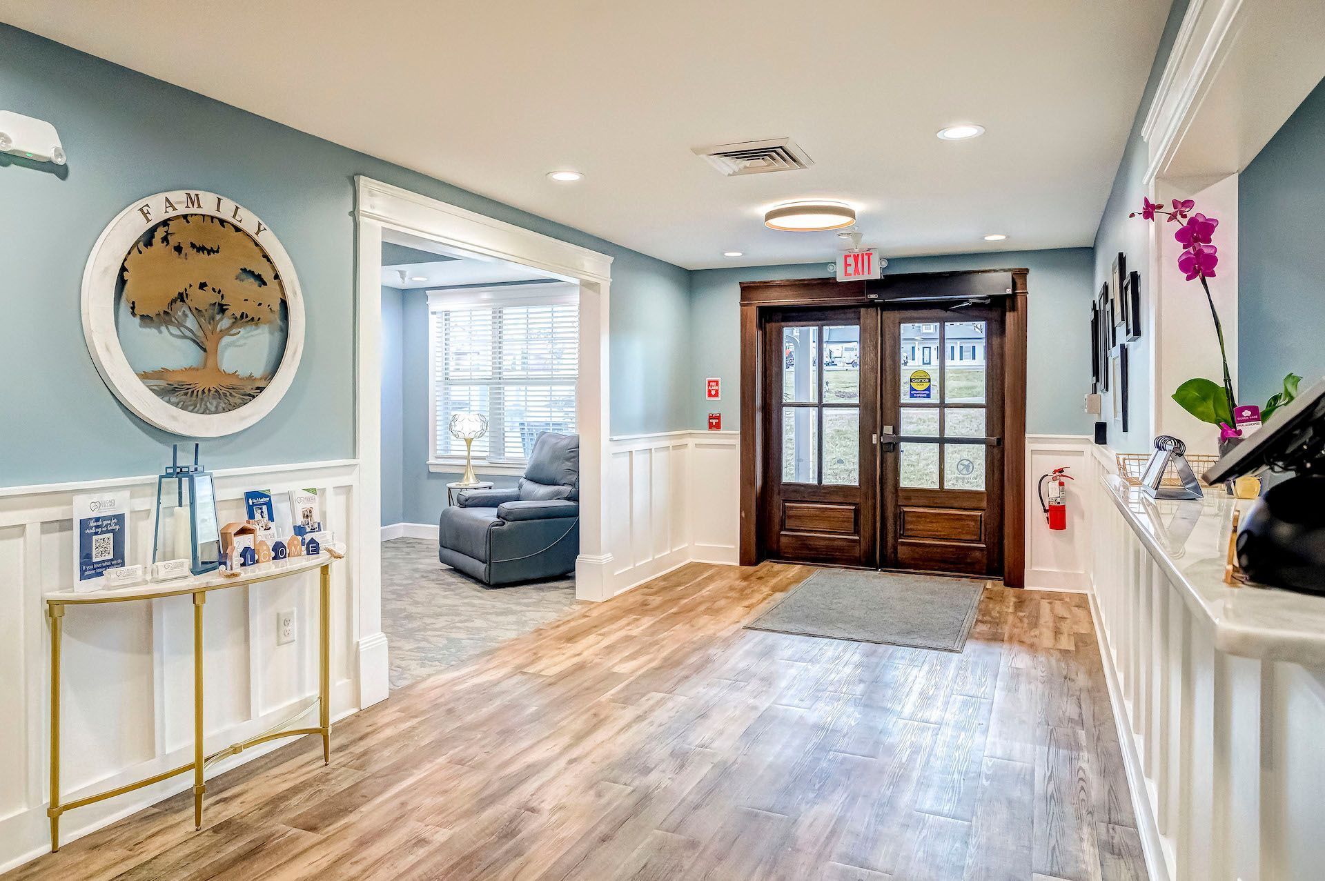 A hallway in a house with a table and chairs in it.