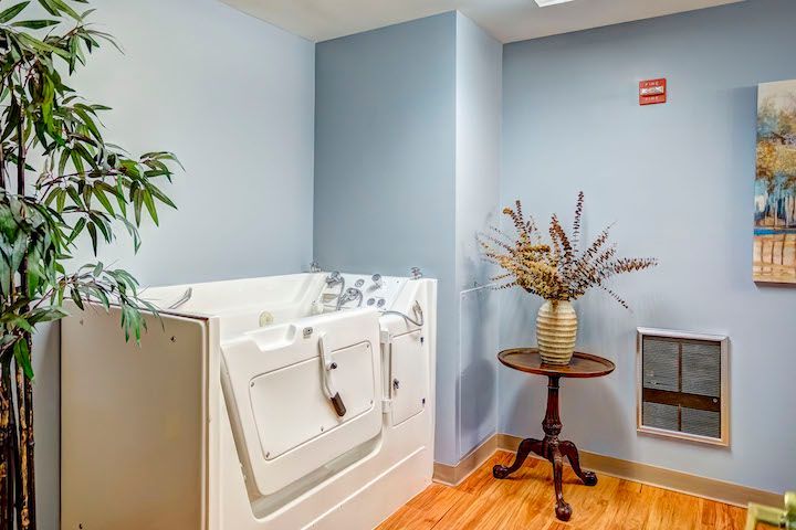 There is a walk in tub in the middle of the room.