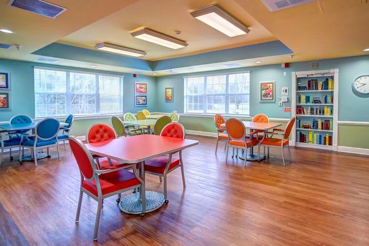 A large room with tables and chairs in it.