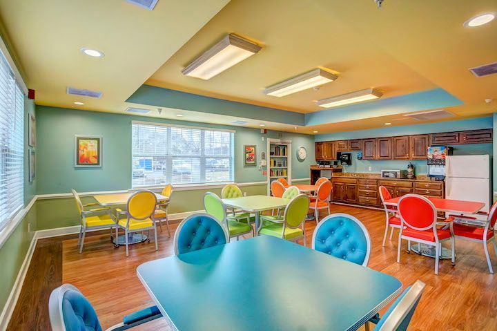 A large room with tables and chairs in it.