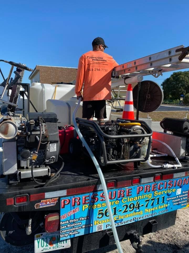 Man in orange shirt on a truck labeled 