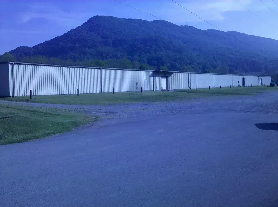 A large white building with mountains in the background