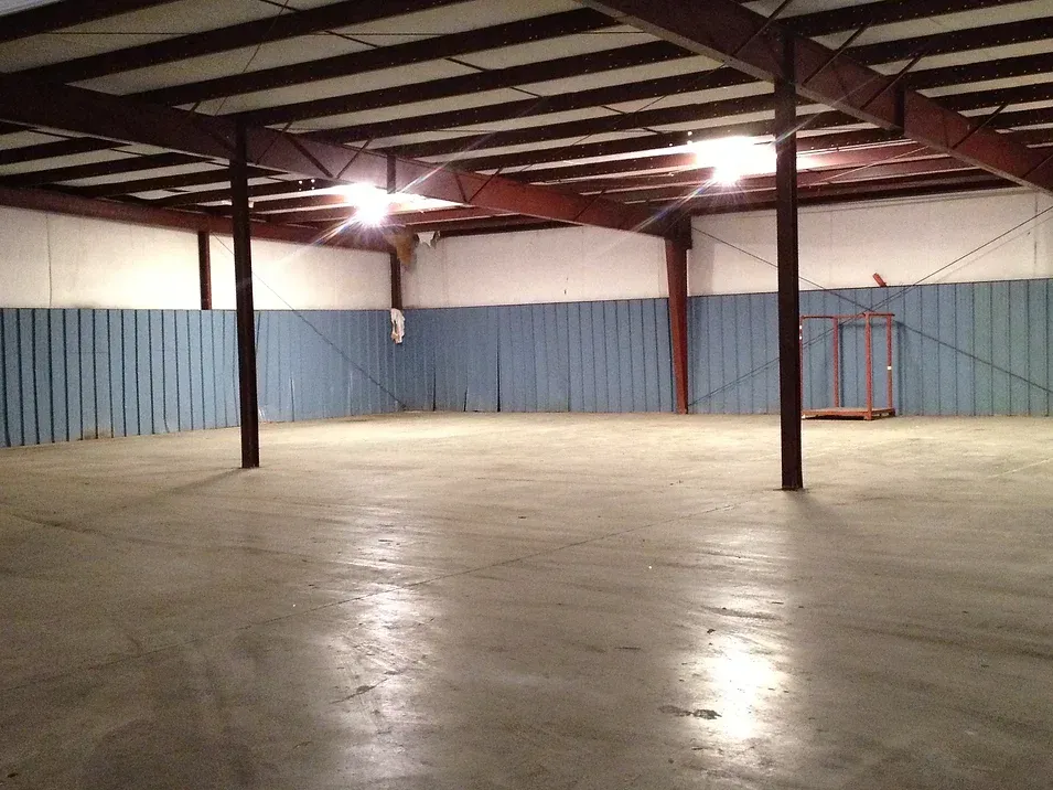 A large warehouse with a concrete floor