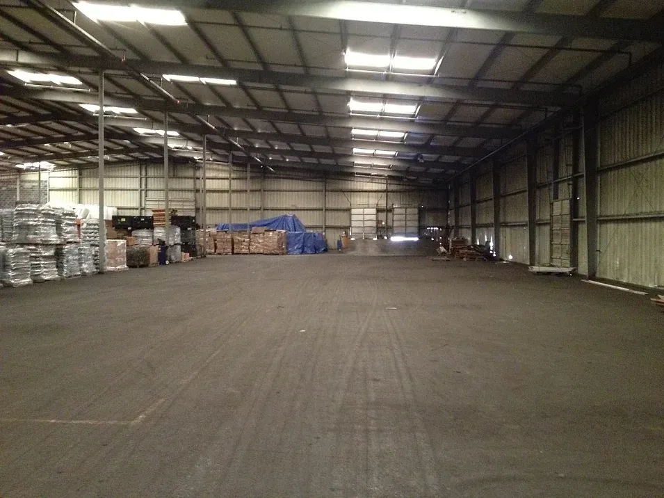 A large warehouse filled with lots of boxes and pallets