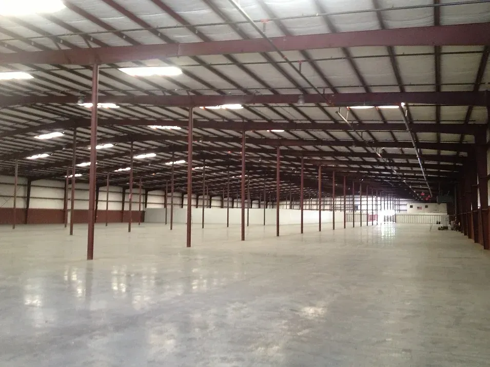 A large empty warehouse with a concrete floor