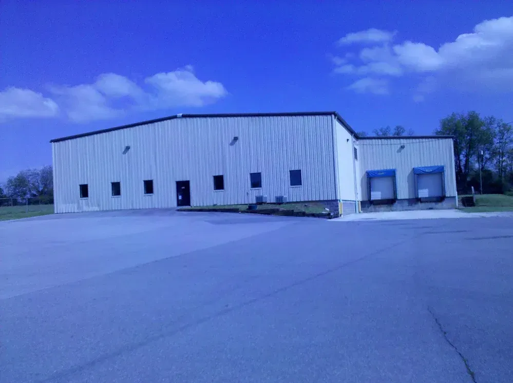 A large white building with a blue sky in the background