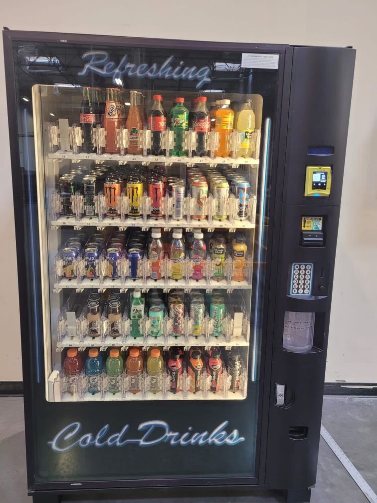 A Vending Machine That Says Refreshing Cold Drinks On It.
