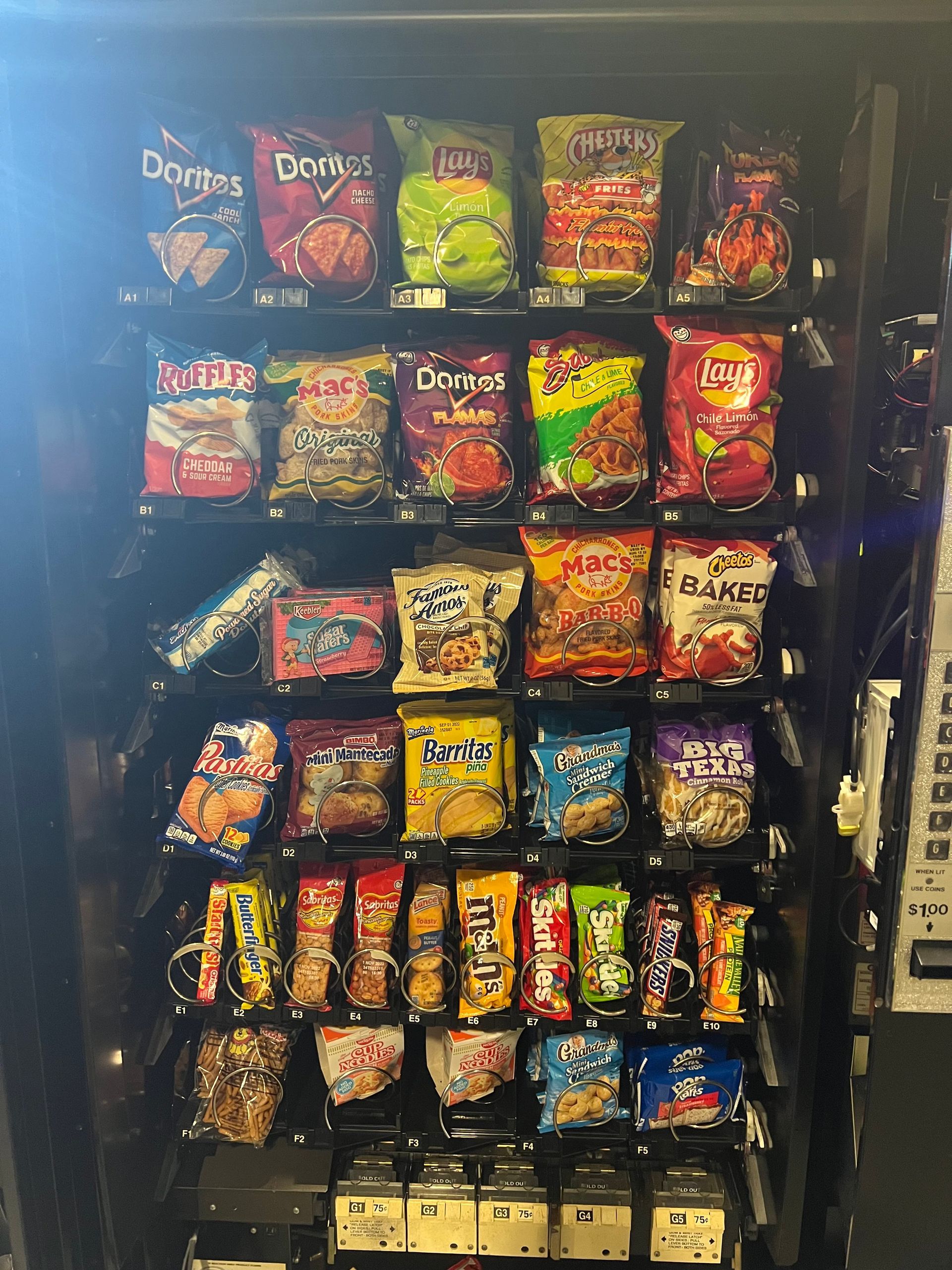 A Vending Machine Filled With Lots Of Different Types Of Snacks.
