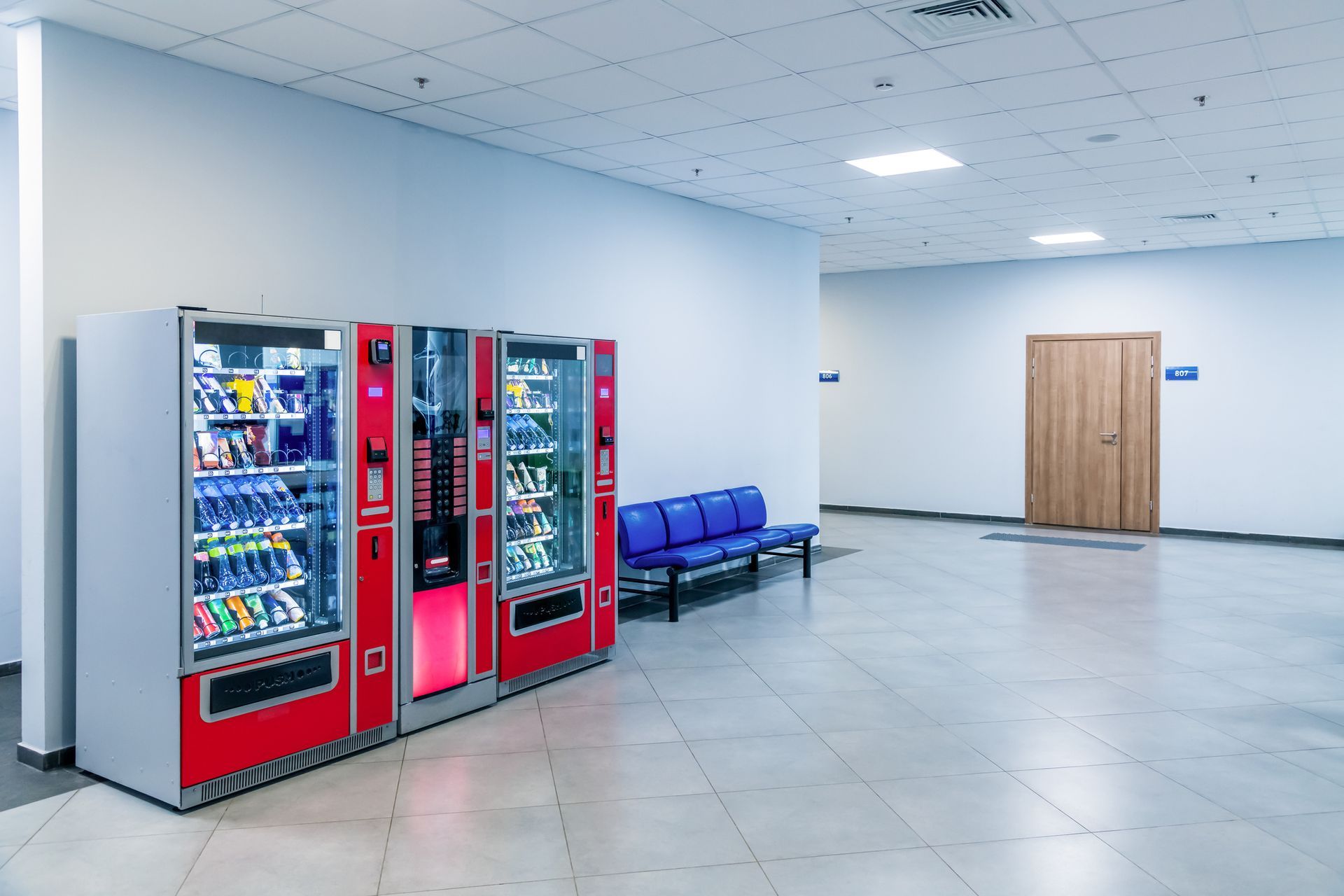 A Young Woman Is Buying A Drink From A Vending Machine.