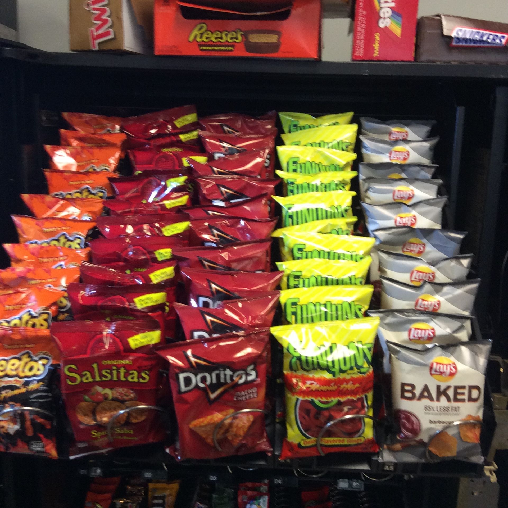 A Vending Machine Of Snacks Including Baked Beans.