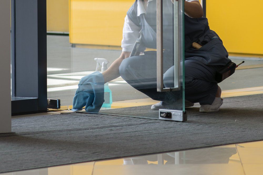 Wiping the Dirt on the Glass Door — DS Cleaning Services in Sunshine Coast, QLD