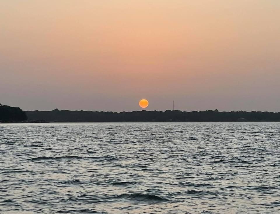 The sun is setting over Cedar Creek Lake