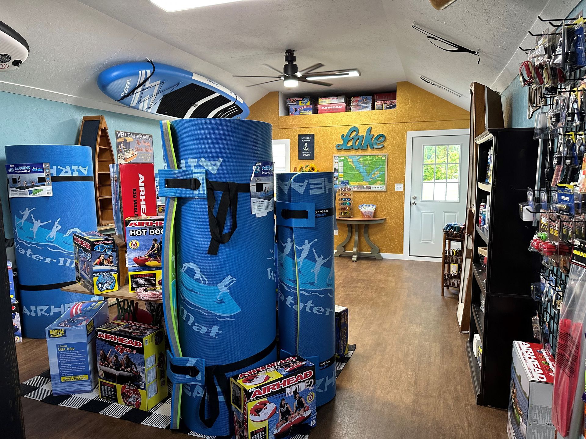 A store filled with lots of water toys and accessories and a sign that says lake
