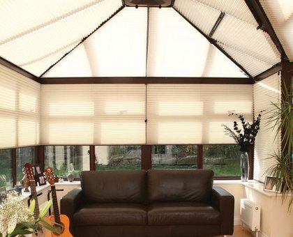 A covered conservatory with pleated blinds
