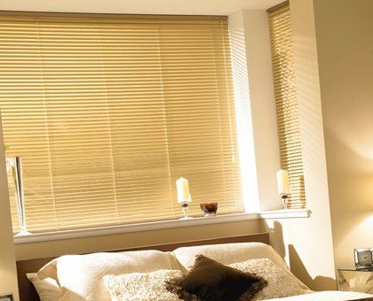 Cream venetian blinds in a bedroom