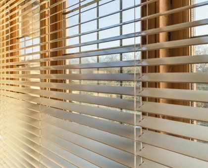 Faux wood blinds with light coming through