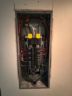 A man is working on a ventilation system in a building.