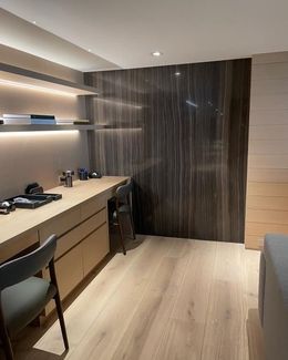 A room with a desk and chairs in it