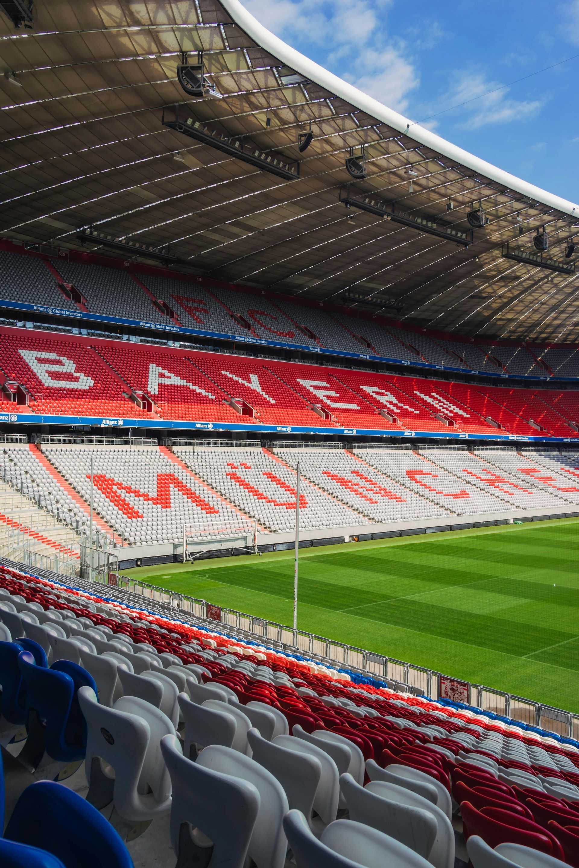 Un estadio de fútbol con asientos vacíos y un campo de fútbol al fondo.