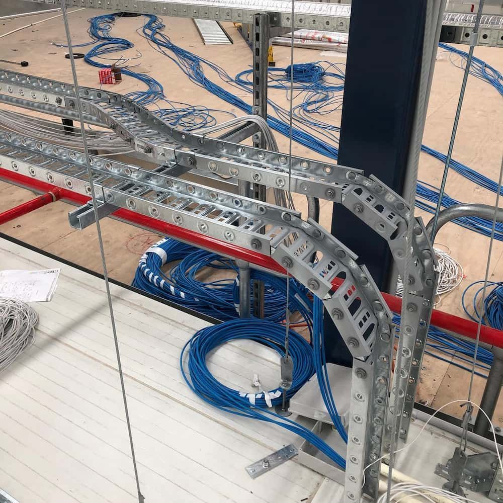 A Bunch of Wires Are Hanging from A Metal Structure — Higgins Electrical in Beerwah, QLD