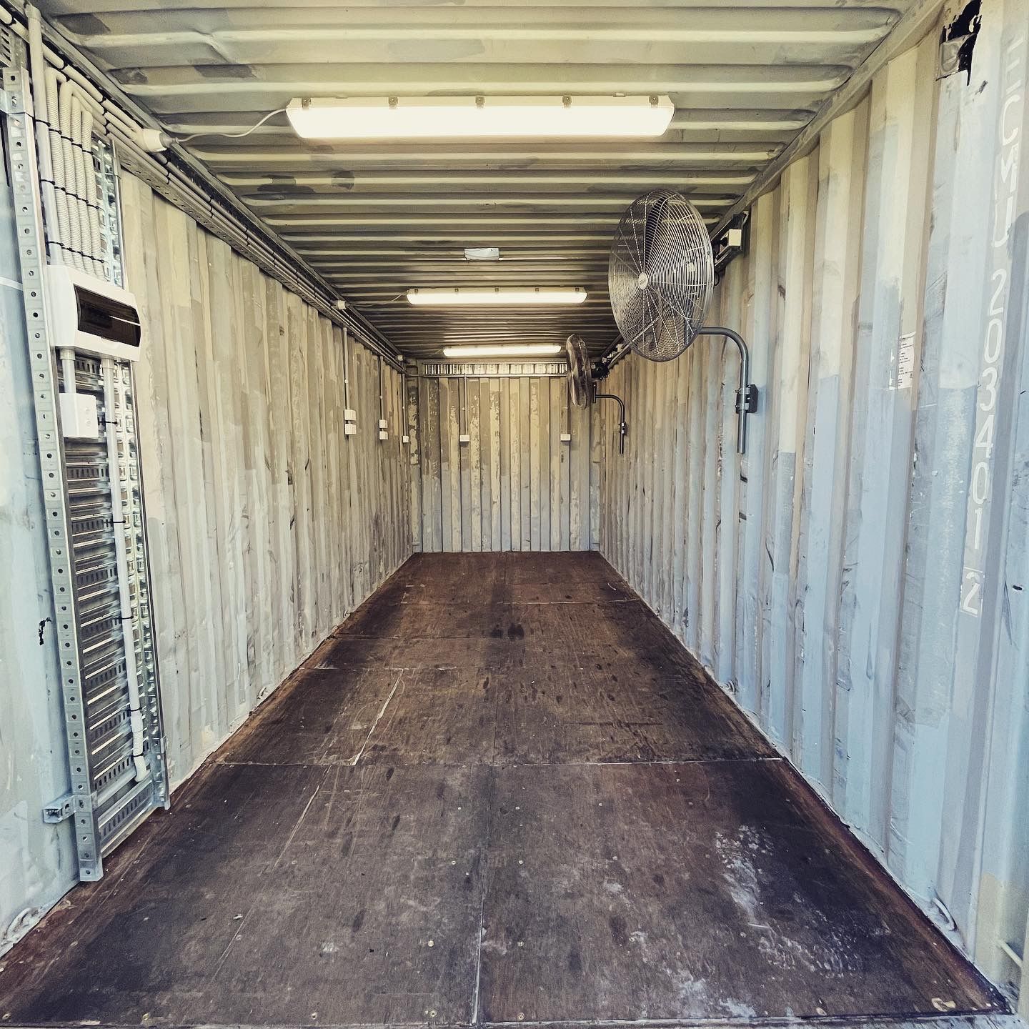 Inside of a Shipping Container, With Lights, a Fan, and a Steel Floor — Higgins Electrical in Nambour, QLD